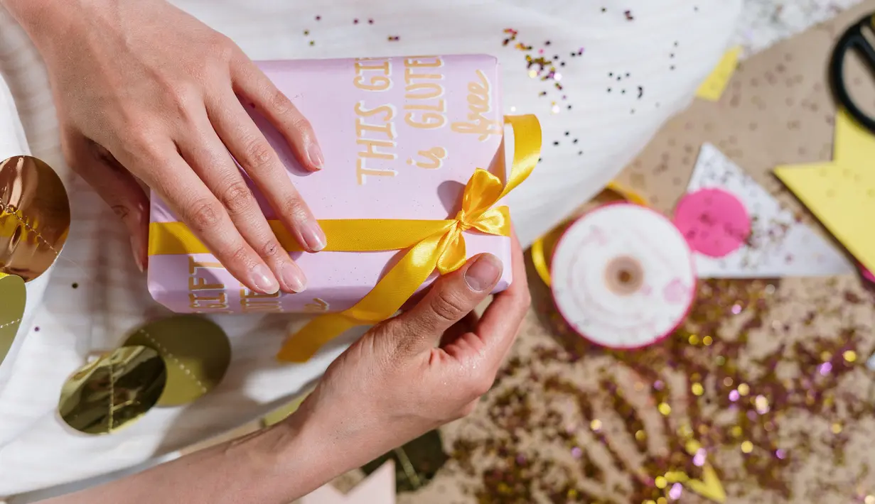 Aksen pita bisa disimpulkan di tepi kado untuk membuatnya tampak lebih istimewa. Warna pita bisa disesuaikan dengan motif kertas kado./Copyright pexels.com/@cottonbro