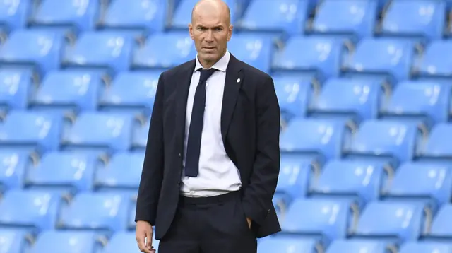 Pelatih Real Madird, Zinedine Zidane menyaksikan pemainnya bertanding melawan Manchester City pada leg kedua babak 16 besar Liga Champions di Etihad Stadium, Inggris (7/8/2020). City menang tipis 2-1 dan melaju ke perempat final unggul agregat 4-2 atas Madrid. (Peter Powell/Pool Photo via AP)