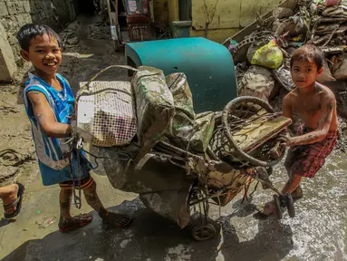 Anak-anak mengumpulkan barang-barang mereka dari endapan lumpur dan sampah beberapa hari setelah bencana banjir yang dipicu oleh Topan Vamco di Marikina City, Filipina, pada 19 November 2020. Dunia merayakan Hari Anak Sedunia tahun ini pada Jumat (20/11). (Xinhua/Rouelle Umali)