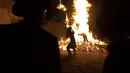 Pemuda Yahudi Ultra-Ortodoks berdiri di samping api unggun selama hari libur Yahudi perayaan Lag Ba'Omer di Bnei Brak, Israel, Kamis (29/4/2021). Liburan Lag Ba'Omer, menandai berakhirnya wabah yang dikatakan telah membinasakan orang Yahudi selama zaman Romawi. (AP Photo/Sebastian Scheiner)