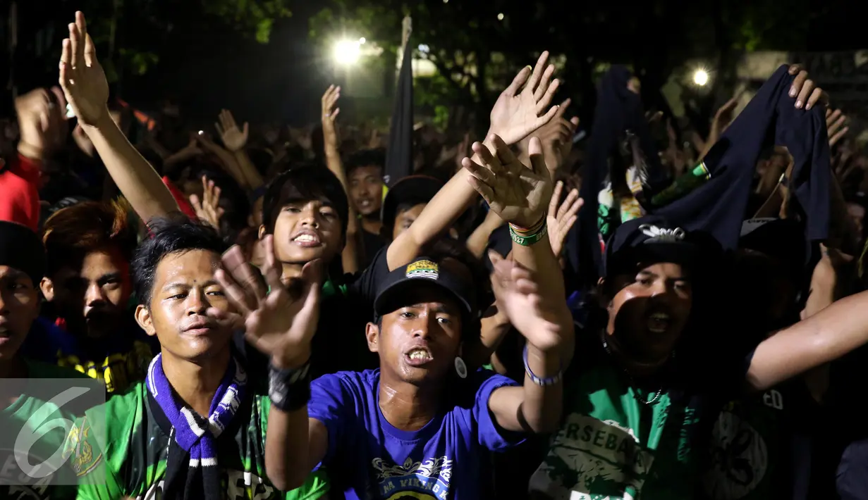 Ratusan pendukung Persebaya bernyanyi menghabiskan malam di GOR Padjajaran, Bandung, Sabtu (7/1). Ribuan suporter Persebaya berkumpul di GOR Padjajaran menunggu keputusan kongres PSSI terkait nasib klub kesayangan mereka. (Liputan6.com/Helmi Fithriansyah)