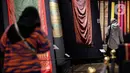 Pengunjung melihat kain tenun di pameran tenun bertajuk "Nuansa Kemilau Wastra Tenun Indonesia" di Museum Tekstil, Jakarta, Rabu (20/7/2022). Pameran dalam rangka memperingati HUT ke - 77 RI ini berlangsung hingga 31 agustus 2022 mendatang dan menampilkan kerajinan tenun dari Sumatera, Sulawesi, dan Timor. (Liputan6.com/Johan Tallo)