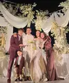 Lesti Kejora dan Rizky Billar sama-sama menjadi bridesmaid dan groomsmen di pernikahan Harris dan Haviza dengan pakaian warna maroon. Lesti tampil dengan long dress lengan panjang puff. Dan Rizky Billar dibalut setelan jas. [@lestikejora]
