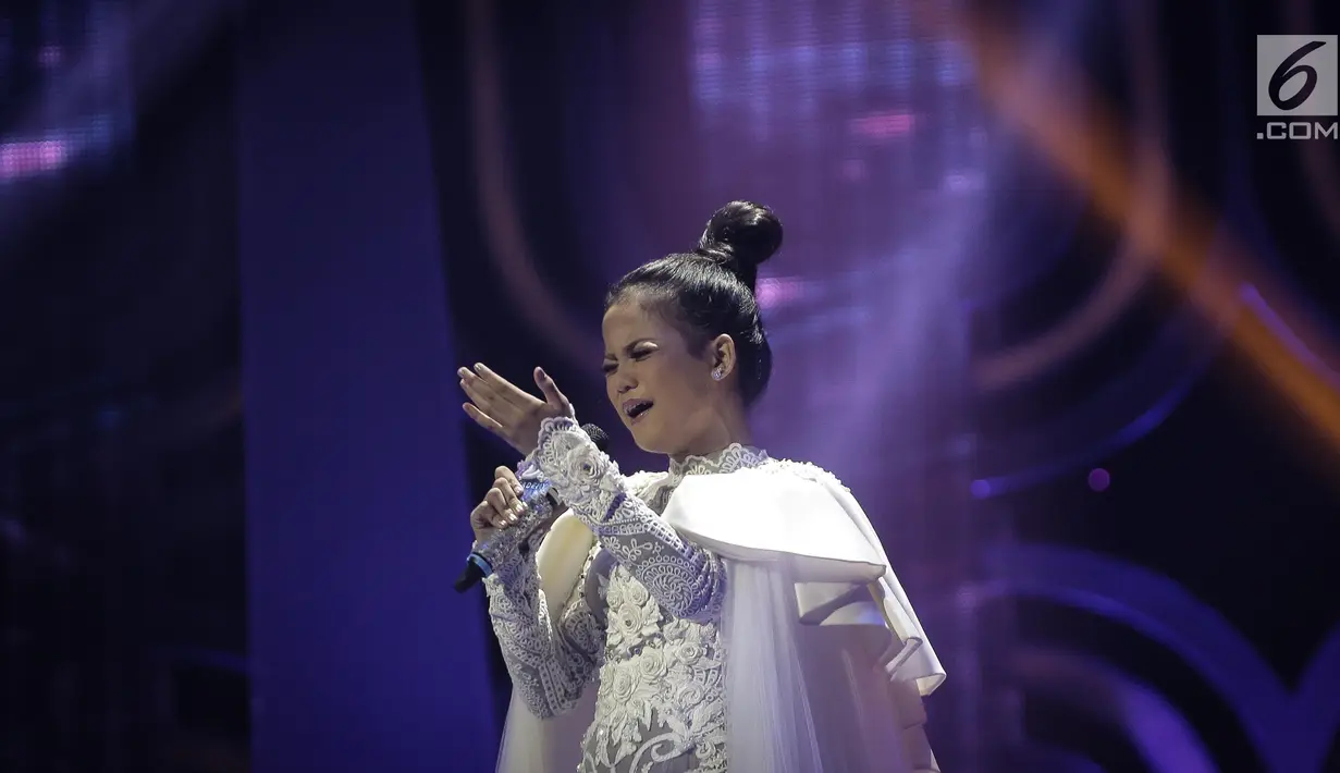 Ekspresi Putri saat berduet dengan Henry Lamiri dan Delicacy dalam grand finalis Dangdut Academy 4 atau D'Academy 4 di Studio 5 Indosiar, Jakarta, Jumat (19/5). (Liputan6.com/Faizal Fanani)
