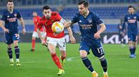 Arsenal harus puas bermain imbang 1-1 kontra Benfica pada pertandingan leg pertama 32 besar Liga Europa di Stadio Olimpico, Jumat (19/2/2021) dini hari WIB. (AFP/Alberto Pizzoli)
