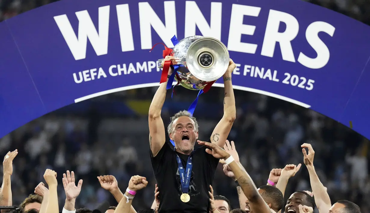 Pelatih PSG, Luis Enrique mengangkat trofi Liga Champions 2024/2025 setelah berhasil mengalahkan Inter Milan dalam laga final yang berlangsung di Allianz Arena, Munchen, Jerman, Minggu (01/06/2025) dini hari WIB. (AP Photo/Matthias Schrader)