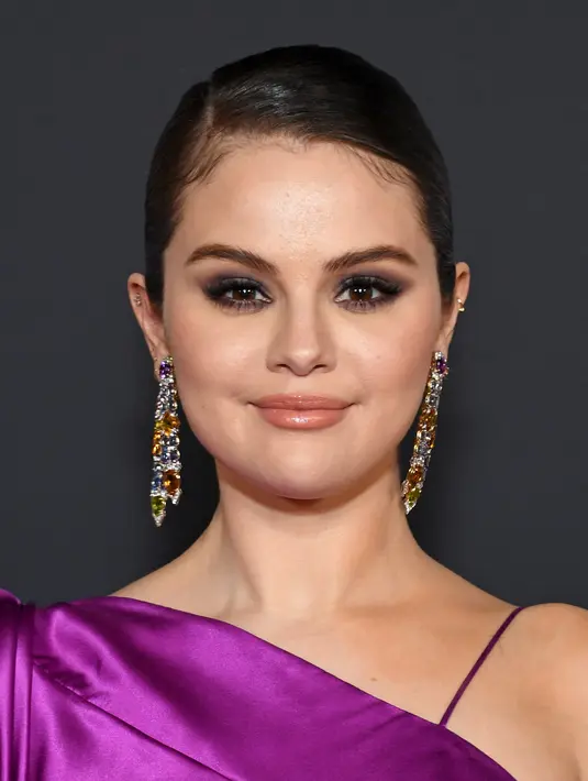 Selena Gomez berpose saat menghadiri pemutaran film "Selena Gomez: My Mind And Me" selama malam pembukaan AFI Fest 2022 di TCL Chinese Theatre di Hollywood, California pada 02 November 2022. Ia juga tampil dengan riasan mata smokey gelap. (Jon Kopaloff/Getty Images/AFP)