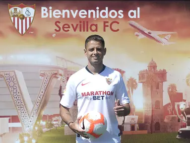 Penyerang baru Sevilla, Javier Hernandez 'Chicharito' berpose dengan jersey klub barunya selama presentasi resminya di Sport City of Sevilla (2/9/2019). Eks penyerang Manchester United dan Real Madrid ini digaet Sevilla dengan mahar yang dikabarkan mencapai 8 juta euro. (AFP Photo/Cristina Quicler)