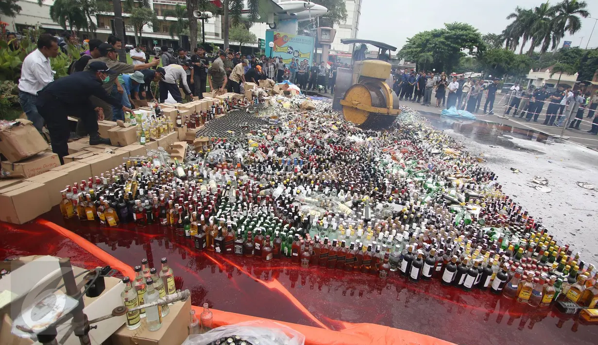 Sebuah alat berat melindas ribuan botol miras ilegal hasil sitaan di Kantor Pusat Bea Cukai, Jakarta, Senin (20/6). Bea dan Cukai melakukan pemusnahan terhadap berbagai hasil temuan senilai Rp46,1 miliar. (Liputan6.com/Immanuel Antonius)