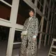 Hadir di fashion show, Dian Sastro kenakan kemeja lengan panjang di balik oversized laser cut outer. Dipadu dengan bawahan pendek dan heels [@therealdisastr]