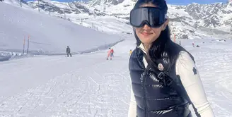 Liburan Dian Sastrowardoyo diisi dengan bermain ski. Ia kenakan baju monokrom yang stylish dengan jaket puffy dan juga kacamata ski yang statement. [Foto: Instagram/ Dian Sastrowardoyo]Nia