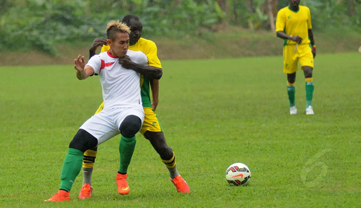 Pemain Timnas U-23 Indonesia, Ryuji Utomo Prabowo (depan) berusaha lolos dari hadangan salah satu pemain asing saat melakukan latih tanding di POR Sawangan, Depok, Rabu (31/12/2014). (Liputan6.com/Helmi Fithriansyah)