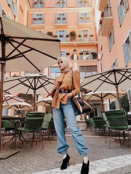 Celana jogger gak hanya bisa dipadukan dengan kaos santai, namun juga dengan blouse polos berpita dan aksesoris belt besar. (Instagram/ollaramlan).