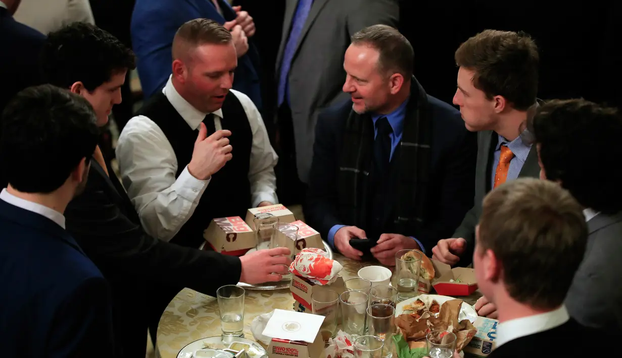 Para pemain Clemson Tigers memakan makanan cepat saji di Gedung Putih, Washington, Senin (14 /1). Gedung Putih menyajikan makanan cepat saji lantaran para koki dirumahkan akibat penutupan sebagian pemerintahan. (AP Photo/Manuel Balce Ceneta)