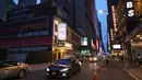 Mobil melewati gedung-gedung teater di Theater District di Manhattan, New York City, Kamis (6/5/2021). Gubernur Andrew Cuomo mengumumkan teater Broadway akan dibuka kembali dalam kapasitas penuh mulai 14 September, sejak ditutup Maret 2020 karena COVID-19. (MICHAEL M. SANTIAGO/GETTY IMAGES VIA AFP)
