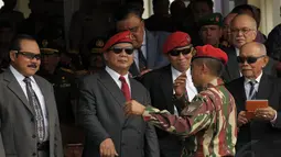 Prabowo Subianto (kedua dari kiri) mendengarkan penjelasan mantan Danjen Kopassus Mayjen TNI Agus Sutomo (berseragam loreng) usai upacara Sertijab Danjen Kopassus di Mako Kopassus, Cijantung, Jakarta, Jumat (24/10/2014). (Liputan6.com/Helmi Fithriansyah)