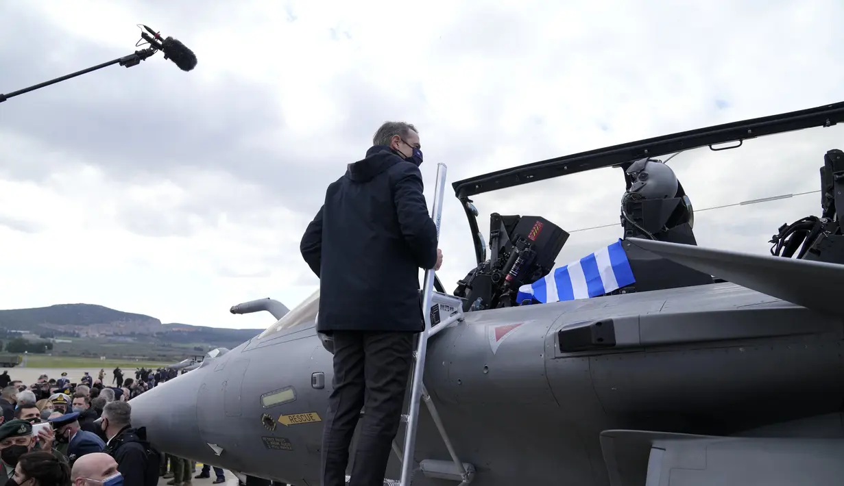 Perdana Menteri Yunani Kyriakos Mitsotakis memeriksa jet tempur Rafale, saat upacara kedatangan jet Rafale pertama dari Prancis, di Tanagra, Yunani (19/1/2022). Yunani telah memesan total 24 jet buatan Dassault dengan biaya lebih dari tiga miliar euro. (AP Photo/Thanassis Stavrakis)