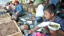 Anak petani Telukjambe melakukan aksi kubur diri di halaman Monas, Jakarta, Senin (1/5). Aksi kubur diri dilakukan untuk mendapat perhatian pemerintah terkait konflik agraria di Telukjambe, Karawang. (Liputan6.com/Yoppy Renato)