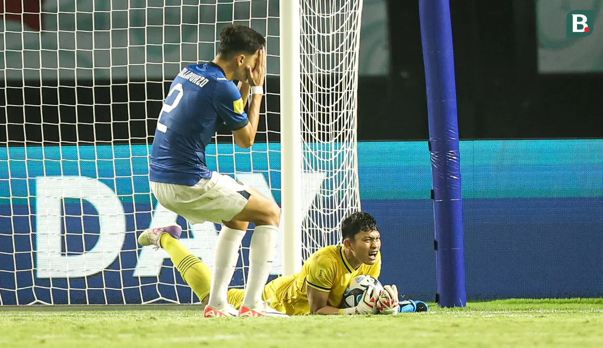 Kiper Timnas Indonesia U-17, Ikram Algiffari berhasil menangkap bola dari ancaman pemain Timnas Ekuador U-17, Jair Collahuazo (kiri) pada laga pertama Grup A Piala Dunia U-17 2023 di Stadion Gelora Bung Tomo, Surabaya, Jumat (10/11/2023). (Bola.com/Bagaskara Lazuardi)