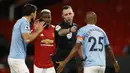 Gelandang Manchester City, Fernandinho (kanan), memprotes keputusan wasit Chris Kavanagh dalam laga lanjutan Liga Inggris 2020/21 pekan ke-12 melawan Manchester United di Old Trafford Stadium, Sabtu (12/12/2020). Manchester City bermain imbang 0-0 dengan Manchester United. (AFP/Phil Noble/Pool)