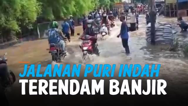 Akibat hujan lebat seharian, hingga siang ini jalanan di kawasan Puri Indah, Jakarta Barat masih terendam air. Sejumlah kendaraan yang nekat melintas sampai mogok.