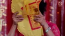 Seorang warga keturunan Tionghoa membawa kertas sembahyang yang akan dibakar di Wihara Amurva Bhumi, Jatinegara, Jakarta, Jumat (16/2). Dalam perayaan Imlek 2018 ini, umat Tionghoa merayakan Tahun Anjing Tanah. (Liputan6.com/Johan Tallo)