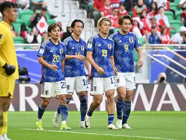 Pemain timnas Jepang Takefusa Kubo (20), Seiya Maikuma (16), Keito Nakamura (13), dan Ayase Ueda (9) berjalan bersama saat pertandingan sepak bola Grup D Piala Asia AFC Qatar 2023 melawan Indonesia di Stadion al-Thumama, Doha, pada 24 Januari 2024. (HECTOR RETAMAL/AFP)