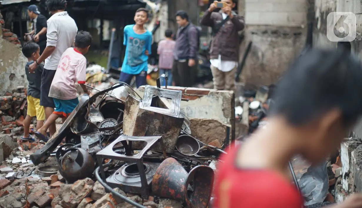 Warga membersihkan puing sisa kebakaran di kawasan padat penduduk di Jalan Kebon Jeruk 4, RT 004 RW 06, Kelurahan Maphar, Kecamatan Taman Sari, Jakarta, Jumat (7/2/2020). Sebanyak 29 unit mobil dikerahkan untuk melakukan pemadaman yang terjadi pada Kamis (6/2) malam. (Liputan6.com/Immanuel Antonius)