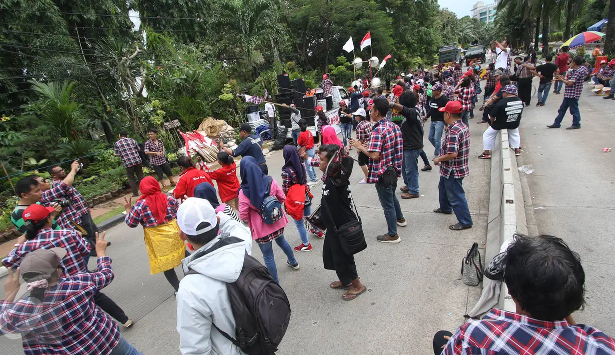 Massa pendukung Ahok berjoget di depan Gedung Kementrian Pertanian, Jakarta Selatan, Rabu (29/3). Dalam sidang ke-16 tersebut tim kuasa hukum menghadirkan 7 saksi ahli untuk meringankan Ahok. (Liputan6.com/Immanuel Antonius)