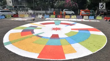 Petugas Prasarana dan Sarana Umum (PPSU) Kelurahan Pegangsaan saat menyelesaikan pembuatan logo Asian Games 2018 di Jalan Penataran atau Simpang Tugu Proklamasi, Jakarta, Rabu (25/7).  (Merdeka.com/Iqbal S. Nugroho)