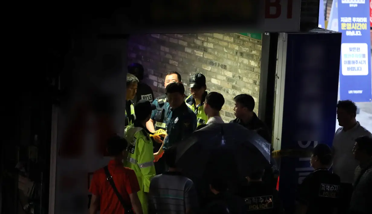 Petugas penyelamat berada di sebuah klub malam  setelah balkon ambruk di kota Gwanju, Korea Selatan (27/7/2019). Kejadian tersebut menyebabkan dua orang tewas dan 10 lainnya cedera, termasuk sejumlah atlet polo air yang akan mengikuti Kejuaraan Renang Dunia. (AFP Photo/Yonhap)