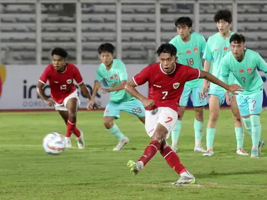 Pemain Timnas Indonesia, Figo Dennis mencetak gol melalui tendangan penalti pada laga persahabatan melawan Timnas China U-20 di Stadion Madya, Senayan, Jakarta, Jumat (22/03/2024). (Bola.com/Abdul Aziz)