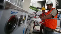 Pekerja memasang instalasi Gaslink PGN di Gedung Kementerian BUMN, Jakarta, Senin (9/10). Gaslink merupakan inovasi PGN memperluas pemanfaatan gas bumi ke masyarakat, salah satunya melalui pendistribusian gas tanpa melalui pipa (Liputan6.com/Angga Yuniar)