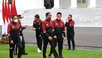 Ketua NOC Indonesia Raja Sapta Oktohari bersama Menteri Pemuda dan Olahraga Zainudin Amali berjalan bersama Presiden RI Joko Widodo pada acara penyambutan Kontingen SEA Games 2021 Vietnam. (Biro Pers Istana/Lukas)