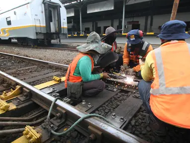 Sejumlah pekerja memperbaiki rel jalur Kerata Api di Stasiun Tugu, Yogyakarta, Selasa (28/6). Perbaikan di lakukan untuk memperlancar arus mudik dengan menggunakan transportasi layanan kereta api. (Liputan6.com/Boy Harjanto)
