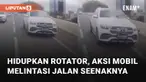 Aksi sebuah mobil bukan ambulans dan petugas kepolisian hidupkan rotator di jalan mengundang perhatian