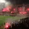 Suporter PSS Sleman menyalakan flare saat bersua Persija Jakarta pada laga pekan ke-33 BRI Liga 1 musim ini di Stadion Maguwoharjo, Sleman, Sabtu (17/5/2025) malam WIB. Meski sempat dihentikan gara-gara asap flare, PSS berhasil menang 2-1 atas Persija. (Bola.com/Ana Dewi)
