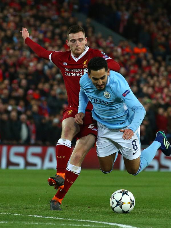 Pemain Manchester City Ilkay Gundogan berebut bola dengan pemain Liverpool Andy Robertson saat pertandingan Liga Champions di Anfield, Liverpool (4/4). Liverpool menang 3-0 atas Manchester City. (AFP Photo/Dave Thompson)