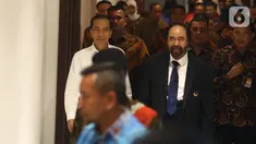 Presiden Joko Widodo atau Jokowi (kiri) didampingi Ketua Umum Partai Nasdem Surya Paloh (kanan) saat menghadiri perayaan ulang tahun ke-8 Partai Nasdem di JIExpo, Jakarta, Senin (11/11/2019). Surya Paloh menyambut langsung kedatangan Jokowi di HUT Nasdem. (Liputan6.com/Angga Yuniar)