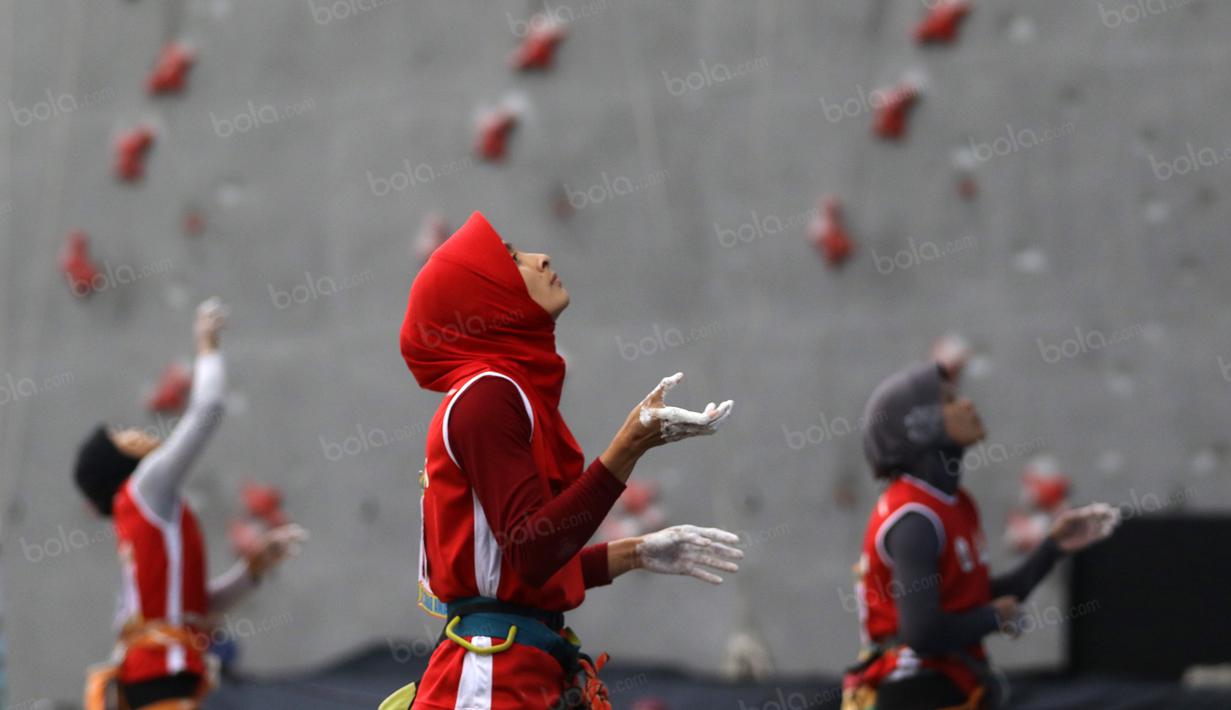 Atlet Panjat Tebing DKI Jakarta, Syarifah (tengah) dan dua rekannya mempelajari track pada kategori Lead Cabang Panjat Tebing PON XIX Jabar 2016 di Cikole, Bandung. (Bola.com/NIcklas Hanoatubun)