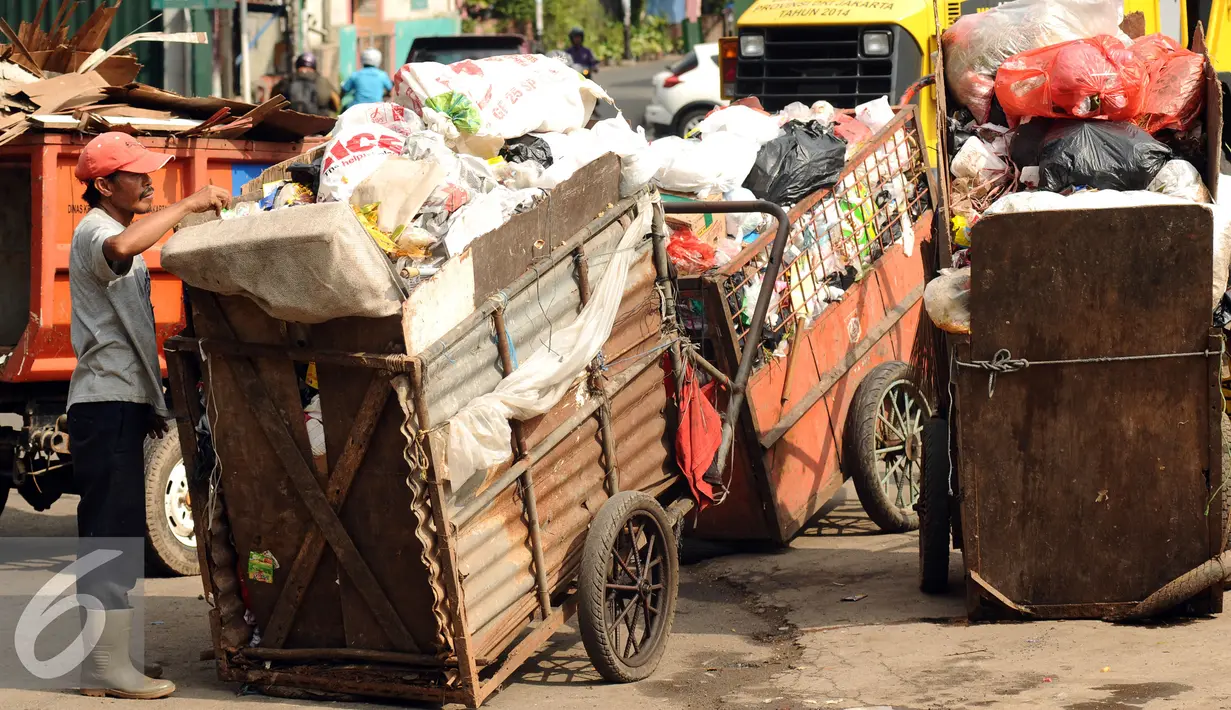 Pekerja menantikan waktu bongkar di Tempat Pembuangan Sampah Sementara Kalibata, Jakarta, Senin (4/1/2016). Dengan digantinya gerobak dengan sepeda motor diharapkan pengangkutan sampah bisa lebih cepat dan efisien. (Liputan6.com/Helmi Fithriansyah)