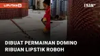 Ribuan lipstik disusun rapi namun dihancurkan dalam sekejap oleh permainan domino mengundang perhatian