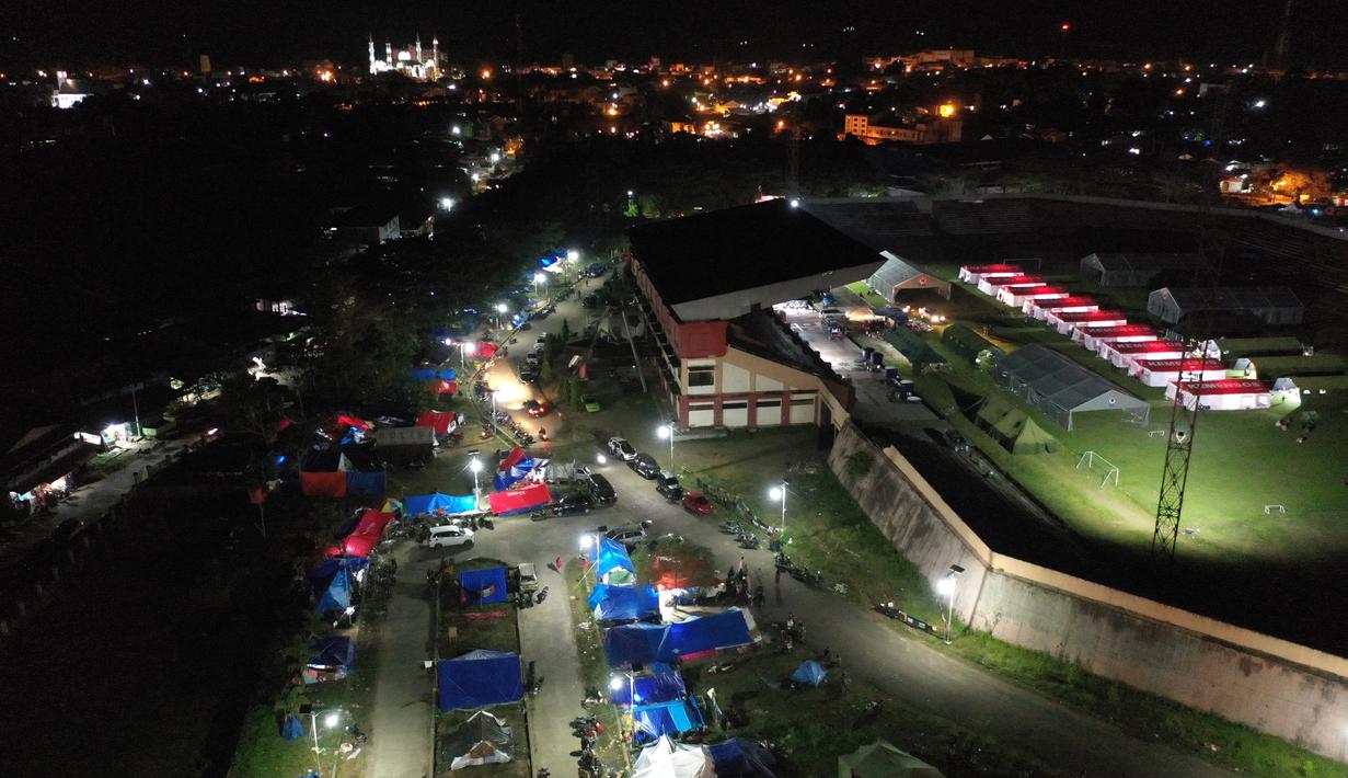 Foto udara menunjukkan tenda-tenda di tempat penampungan darurat di Mamuju (19/1/2021). Tempat pengungsian ini dibangun untuk orang-orang yang terdampak gempa berkekuatan 6,2 yang mengguncang pulau Sulawesi pada 15 Januari 2021. (AFP/Adek Berry)