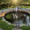 Inspirasi Kolam Ikan yang Menyatu dengan Area Santai Keluarga. Foto: Gemini
