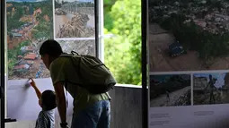 Pengunjung melihat karya pameran foto jurnalistik Prahara Pulau Emas di Museum Tsunami Aceh, Banda Aceh, Aceh, Sabtu, 8 Agustus 2026. (AFP/ Chaideer Mahyuddin)