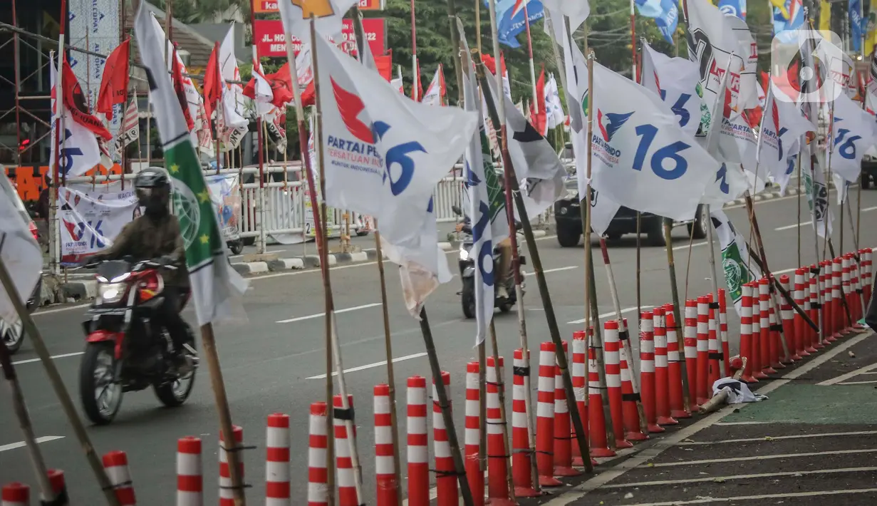 Pemasangan bendera parpol di  jalur sepeda sangat membahayakan pengendara yang melintas. (Liputan6.com/Angga Yuniar)