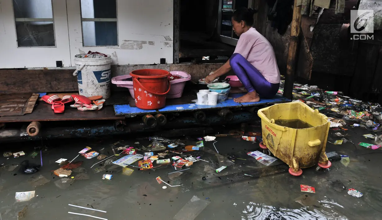 Warga beraktivitas saat banjir rob menggenangi permukiman Muara Angke, Jakarta, Selasa (22/1). Banjir air laut pasang atau Rob yang kembali melanda kawasan itu sejak 6 hari lalu membuat aktivitas warga sekitar terganggu. (Merdeka.com/Iqbal S. Nugroho)