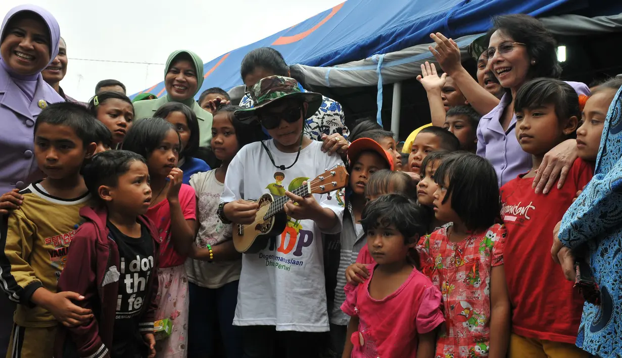 Tegar yang muncul dengan topi dan kacamata hitam mampu menghibur para korban erupsi gunung Sinabung terutama anak-anak (Liputan6.com/Johan Tallo).