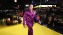Dwayne Johnson berpose untuk fotografer saat tiba pada pemutaran perdana film 'Black Adam' di London, Inggris, 18 Oktober 2022. Dwayne Johnson mengenakan tuksedo satin ungu yang nyentrik. (Photo by Vianney Le Caer/Invision/AP)