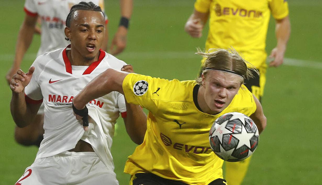 Striker Borussia Dortmund, Erling Haaland, berebut bola dengan pemain Sevilla, Jules Kounde, pada laga Liga Champions di Stadion Ramon Sanchez Pizjuan, Kamis (18/2/2021). Dortmund menang dengan skor 2-3. (AP/Angel Fernandez)